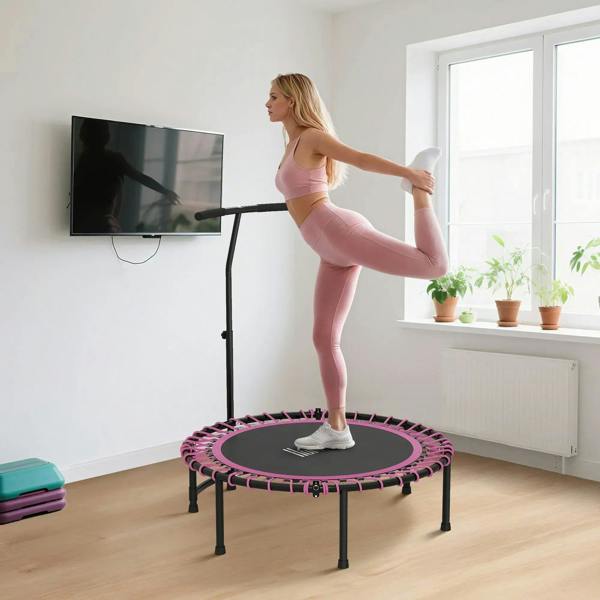 Pink mini trampoline with adjustable handle and black legs in home workout