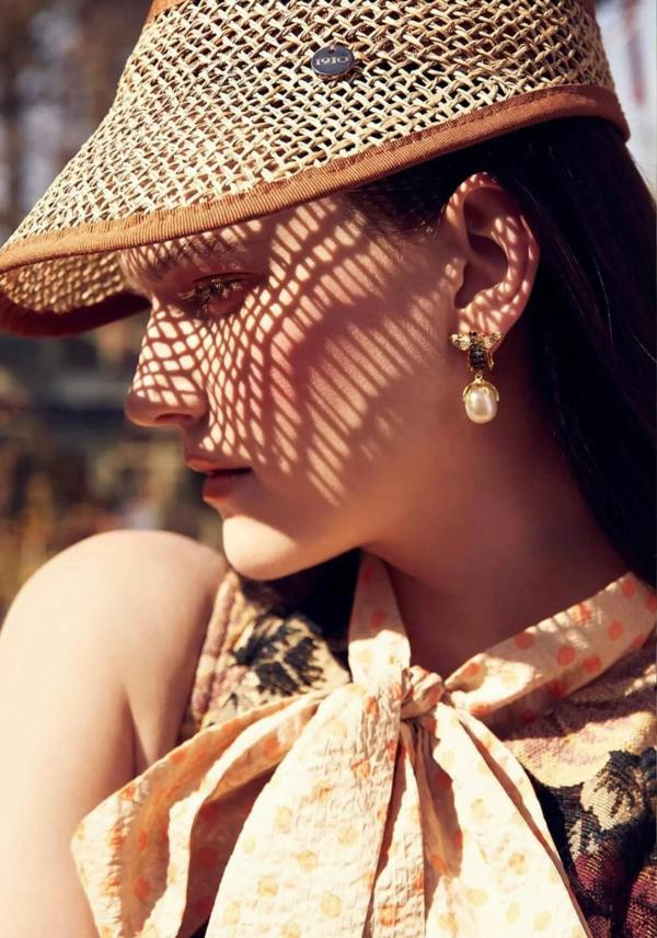 The earring worn by a model.