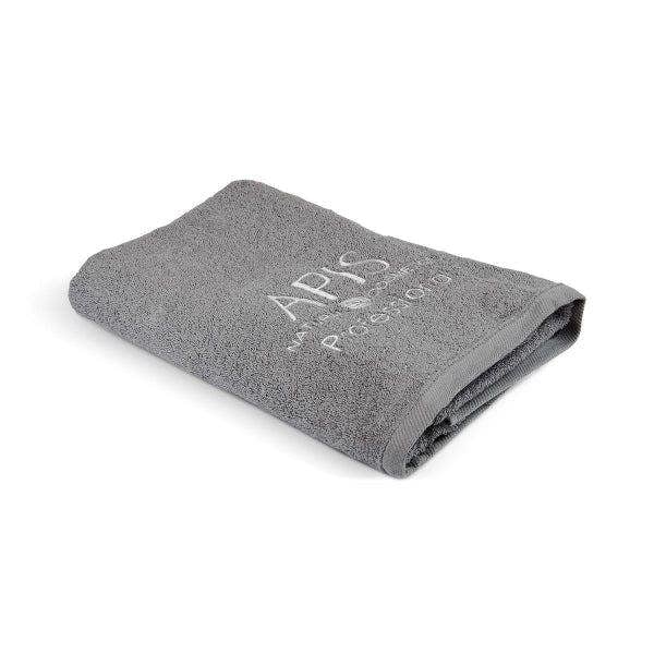 Folded gray towel with 'APIS' branding on a white background