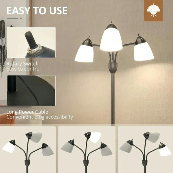 Black tree-style floor lamp with three adjustable heads and three white shades; close view