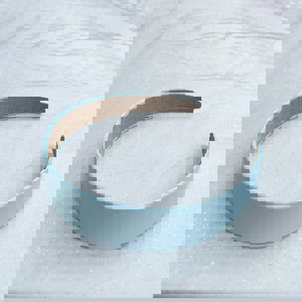 Light blue hairband, smooth satin finish, soft pastel shade, padded structure, minimalist design, elegant everyday accessory
