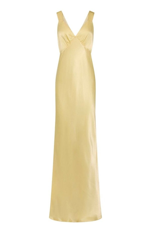 A flowing lemon yellow bridesmaids v-neck dress with thick straps, made from soft pastel pale butter yellow satin.