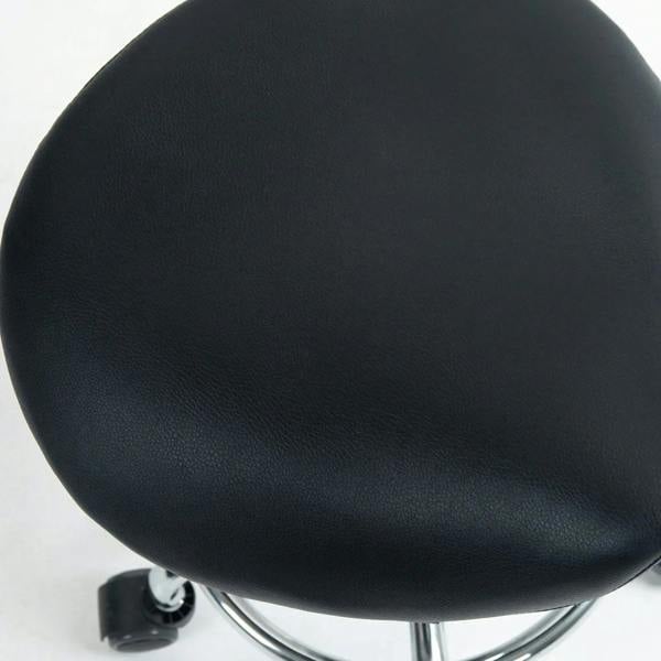 Black cushioned saddle seat with textured upholstery on rolling stool base