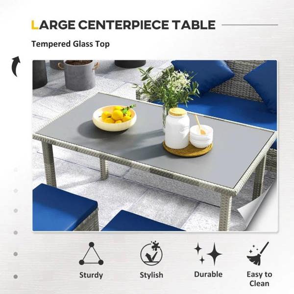 Large center dining table with tempered glass top and dark blue cushions on rattan frame