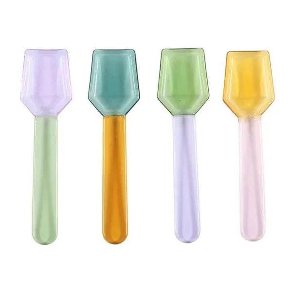 Four pastel glass dessert spoons: lavender, mint, light green, and yellow faceted bowls