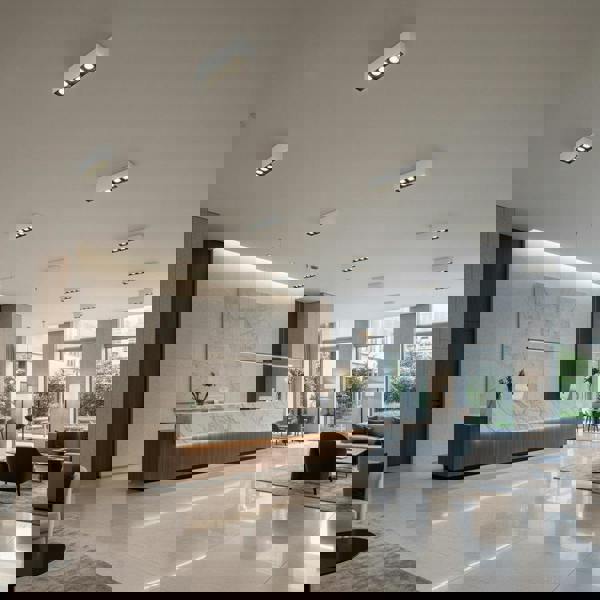 white modern flush ceiling lamp mounted on the ceiling in a hotel reception 