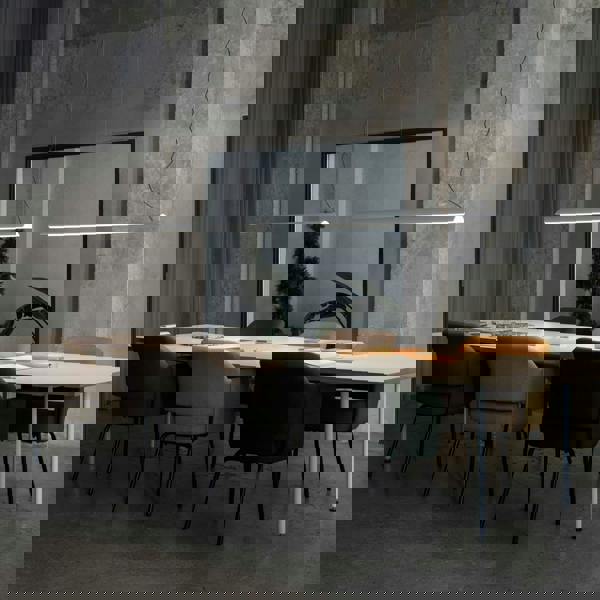 White modern linear pendant light on a grey background with table and chairs