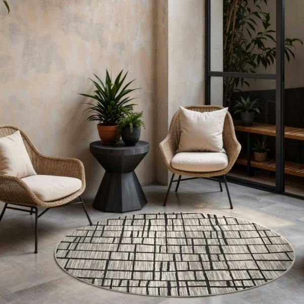 Modern living room with wicker chairs, a round rug, and decorative plants.