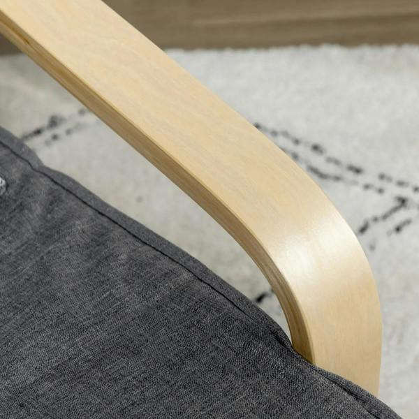 Close-up of light wood armrest on dark grey upholstered lounge chair