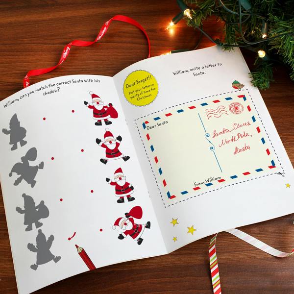 Open view of the Personalised Christmas Activity Book showing a Santa shadow matching activity and a cut-out Letter to Santa page personalised for William