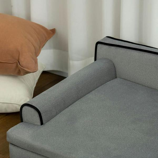 Grey dog sofa corner with padded cushion and black-trim armrest