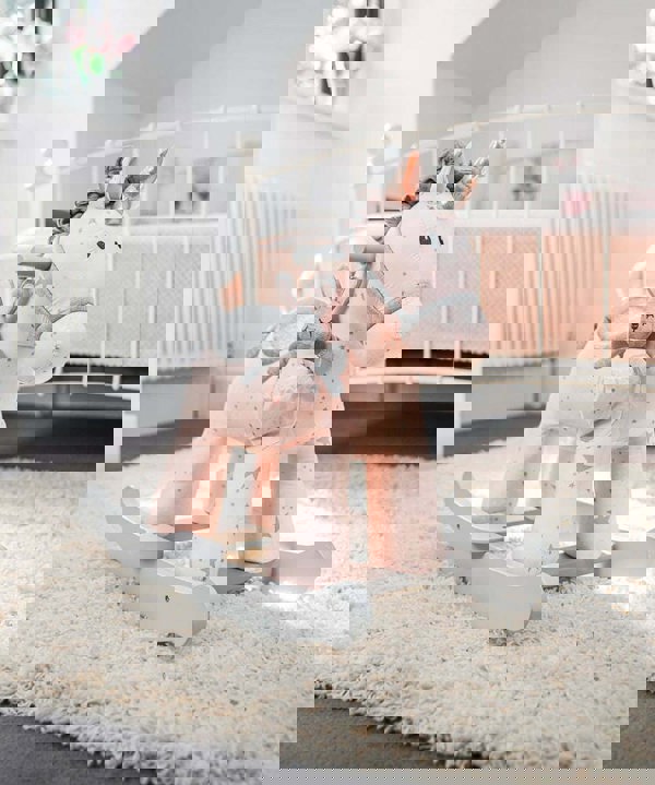 unicorn rocking horse in pink room 