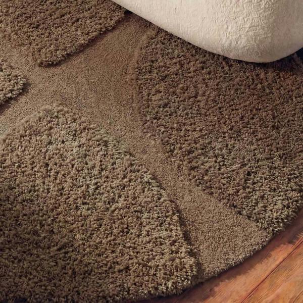 Brown textured rug on a wooden floor