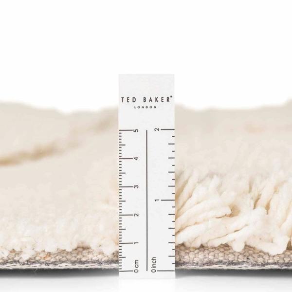 Close-up of a textured surface with a Ted Baker ruler for scale on a white background