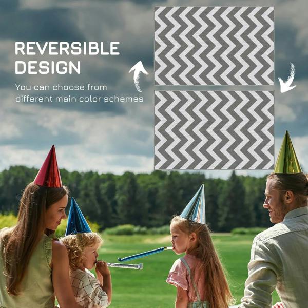 Reversible outdoor rug mat in light grey and white with zigzag chevron pattern