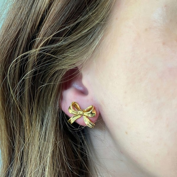 gold bow earrings, ribbon shaped studs, dainty gold earrings, elegant bow jewellery, classic gold accessories for everyday wear
