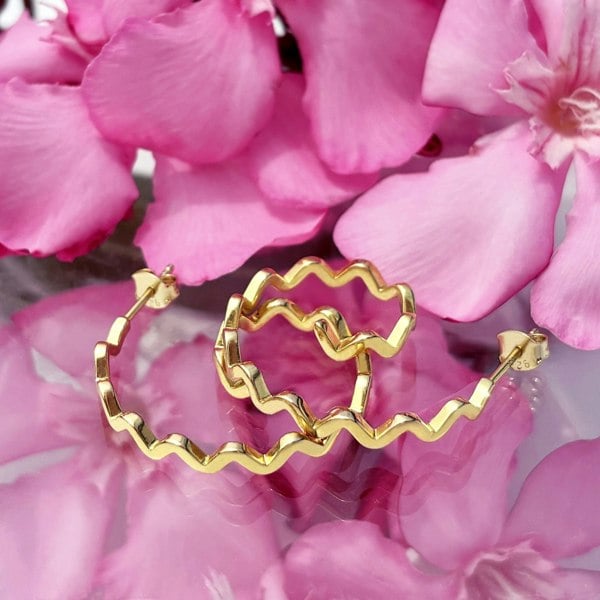 Spiral gold hoops by LENAE London, zig zag design.