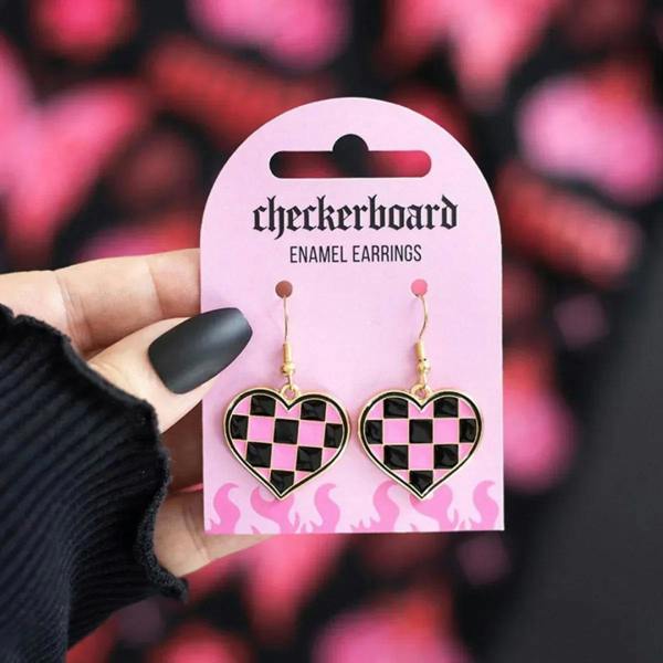 Enamel heart earrings with black and pink checkerboard hearts on gold hooks