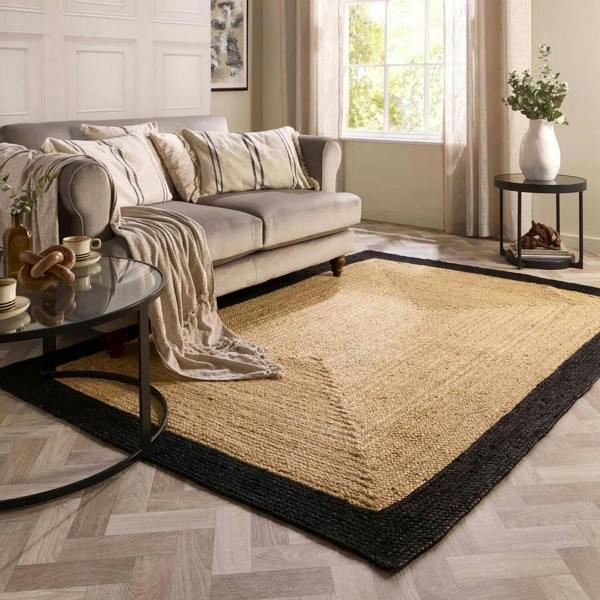 Living room with a beige rug, sofa, and coffee table.