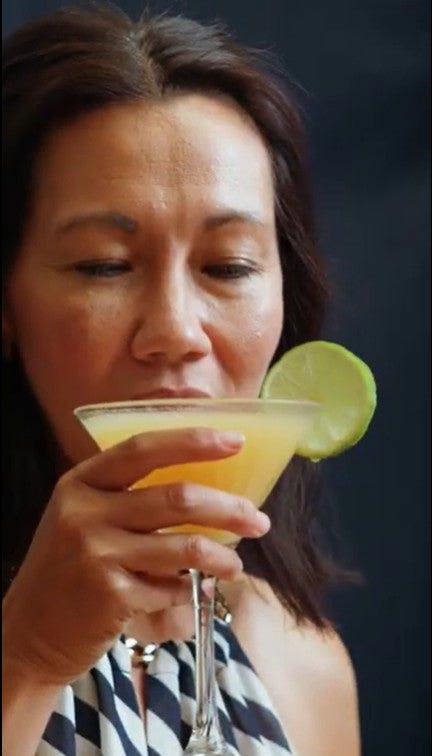 Woman Drinking A Cocktail Made From a Natural & Noble Cocktail Making Kit 