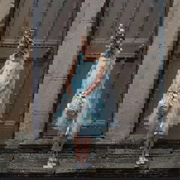 Flower girl holding basket looking to left