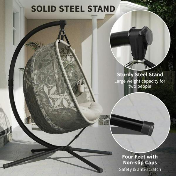 Outdoor hanging chair with patterned canopy, padded seat, and solid steel tripod base