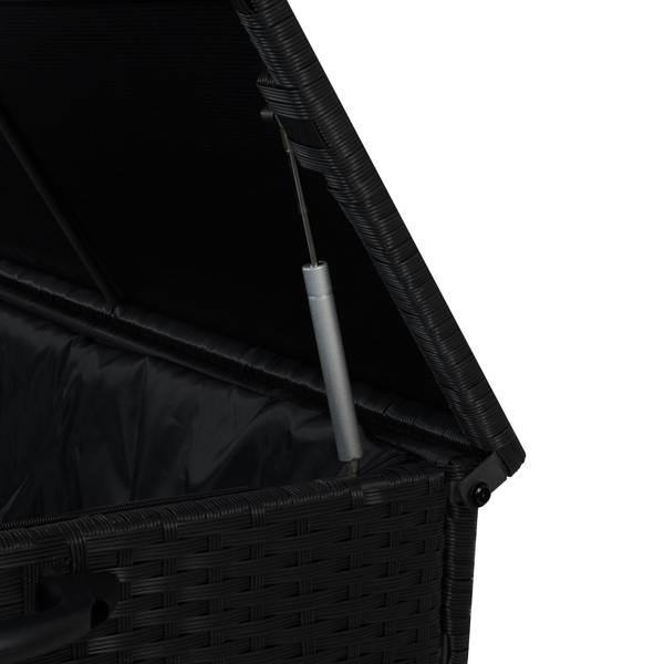Black rattan cushion storage box with a textured weave, open lid, and sturdy silver hinge, perfect for outdoor or indoor use