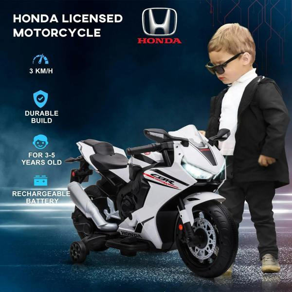 White Honda-licensed kids ride-on motorcycle, child standing beside in yard