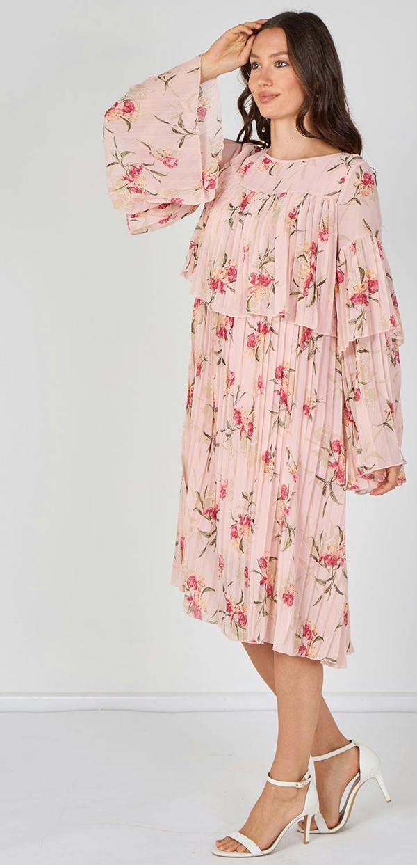 Woman wearing a pink floral dress against a white background