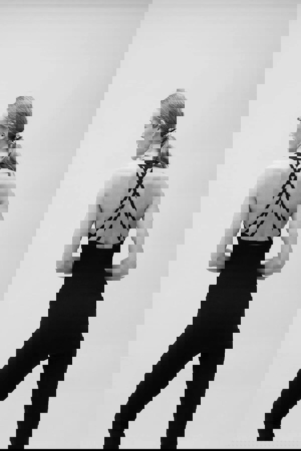 Black seamless sculpting shaping one piece bodysuit with built in shelf bra and removable pads for yoga, pilates, gym and exercise.