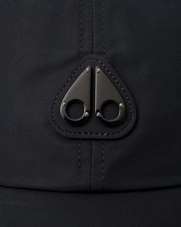 logo detail of a Moose Knuckles Mens Vick Cap in Black 292