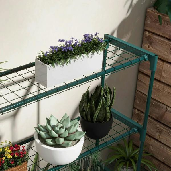 Close-up of green wire-grid plant shelf with potted succulents and snake plant.