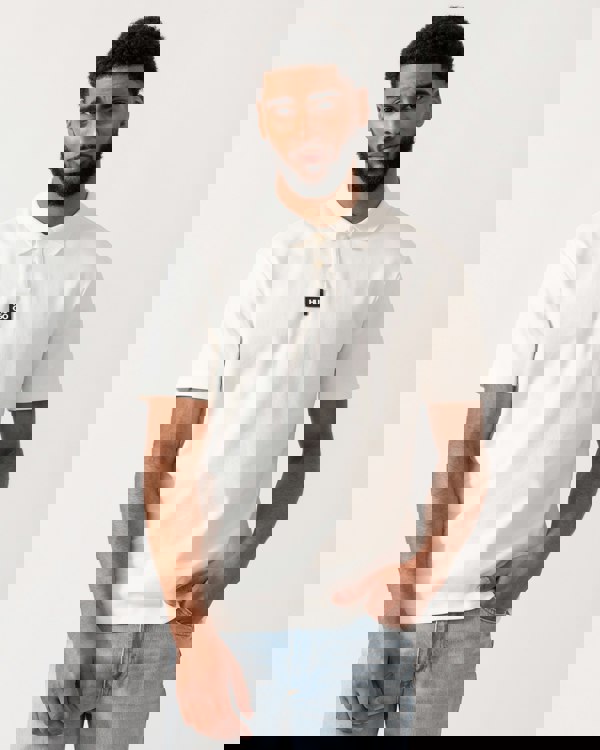 model wearing a HUGO Deabono Mens Interlock Cotton Polo Shirt with Stacked Logo in Natural white