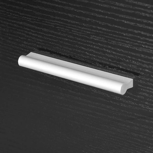 White strip handle on a black drawer front, styled with a smooth metal pull