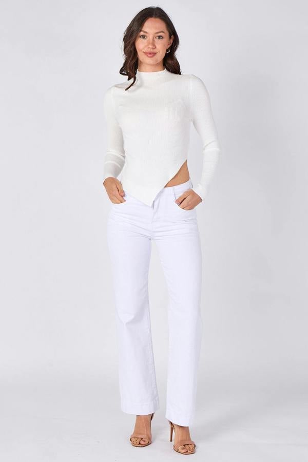 Woman wearing a white sweater and pants on a white background