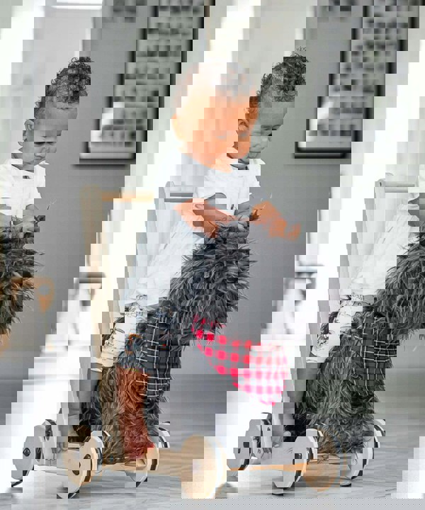 Girl riding scottie dog baby walker