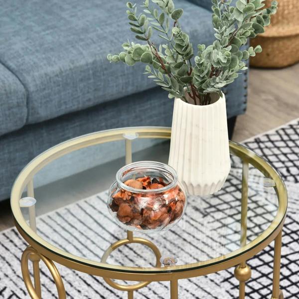 Gold-tone round coffee table with clear glass top and openwork side frame