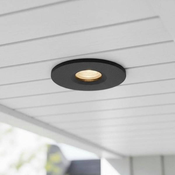 black small outdoor downlight mounted under the soffit of a modern home