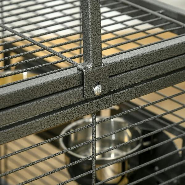 Black speckled metal cage corner joint with screw and wire mesh bars.