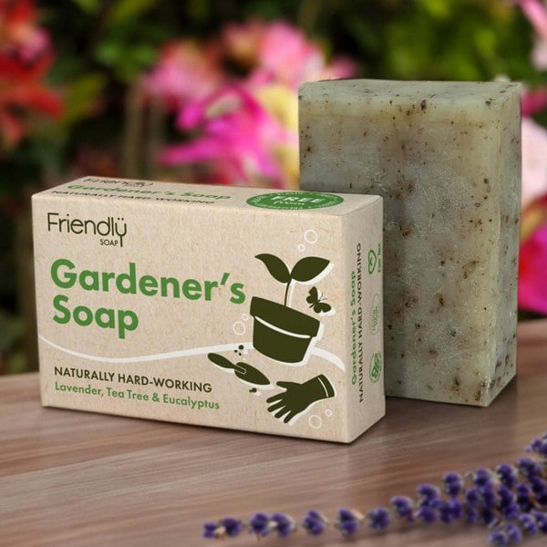 Gardener’s soap bar in a greenhouse with flowers in the background