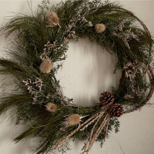 Close-up of the Elowen wreath showing the texture of natural panchu sticks, moss, and thistles.