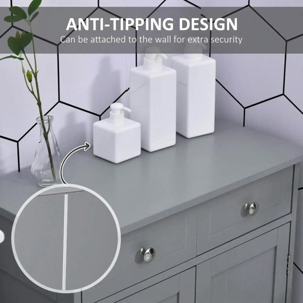 Grey freestanding bathroom cabinet with tabletop, two drawers, and metal door handles