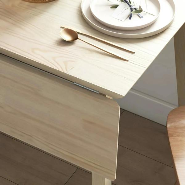 Natural wood drop-leaf table leaf edge and smooth fold mechanism detail