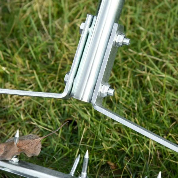 Metal spike support bracket with sharp spikes mounted on rolling aerator frame