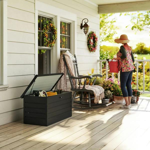 Dark grey steel garden storage box with open lid holding outdoor items