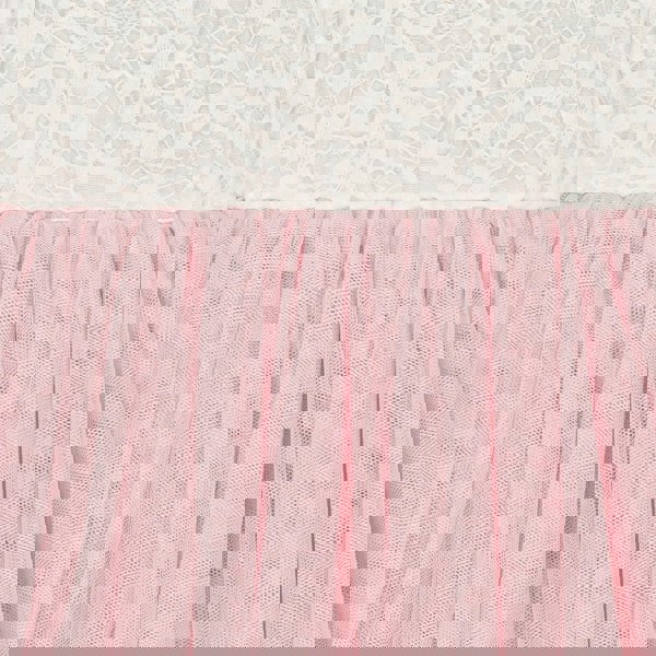 Close-up of pink tulle fabric with white lace in the background