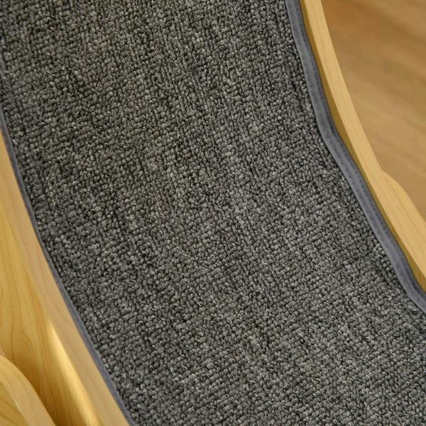 Close-up of dark grey cushioned running track inside natural wood cat wheel