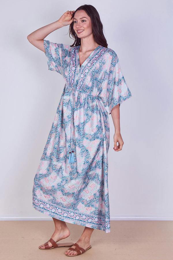 Woman wearing a floral dress against a white background