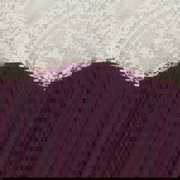 Close-up of a purple garment with white lace trim
