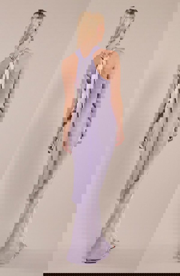 Model wearing halterneck satin bridesmaids dress in a shade of pastel lilac showing back detail.